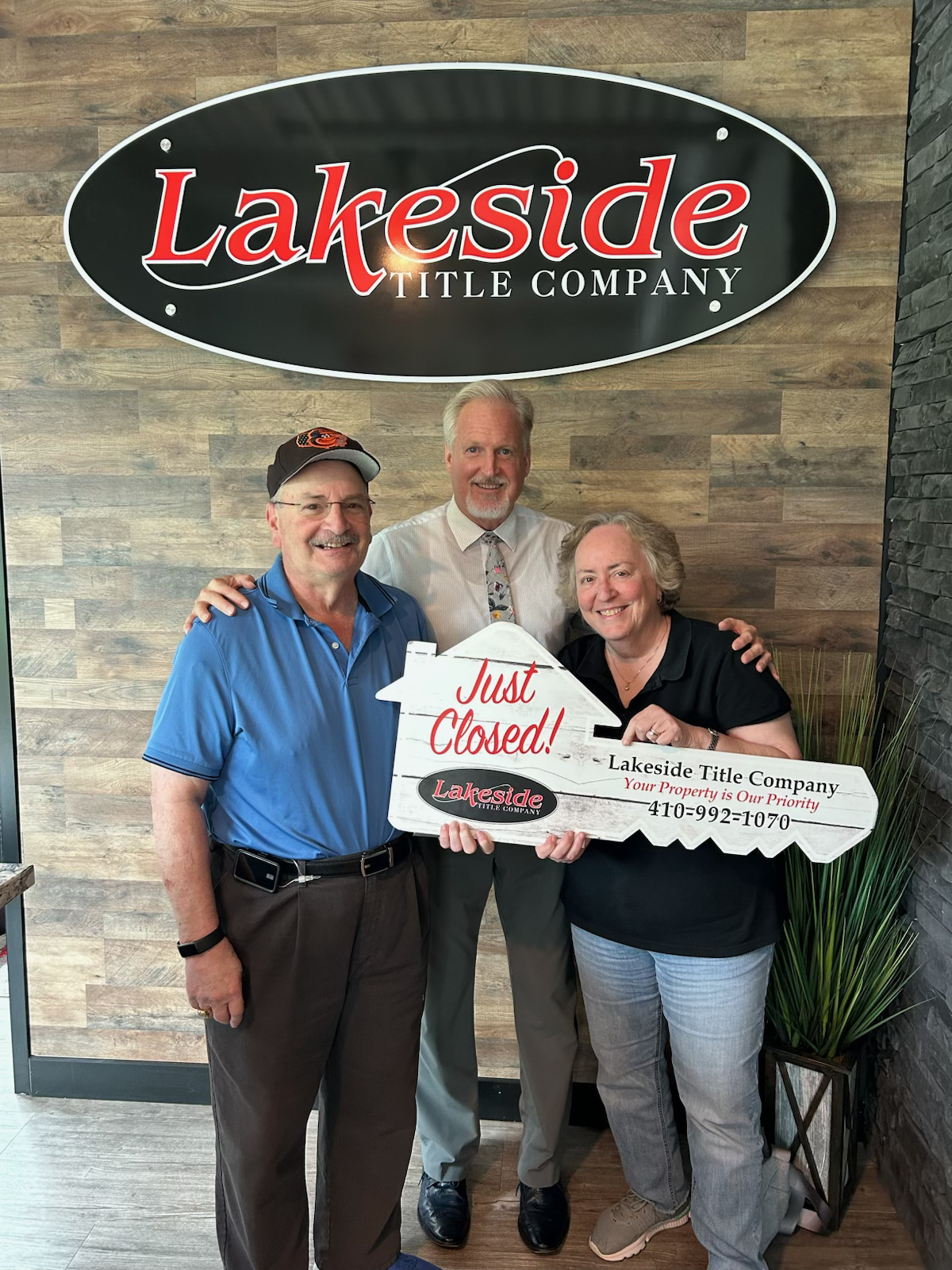 Jim Gladden celebrating a Just Closed! moment with happy clients at Lakeside Title