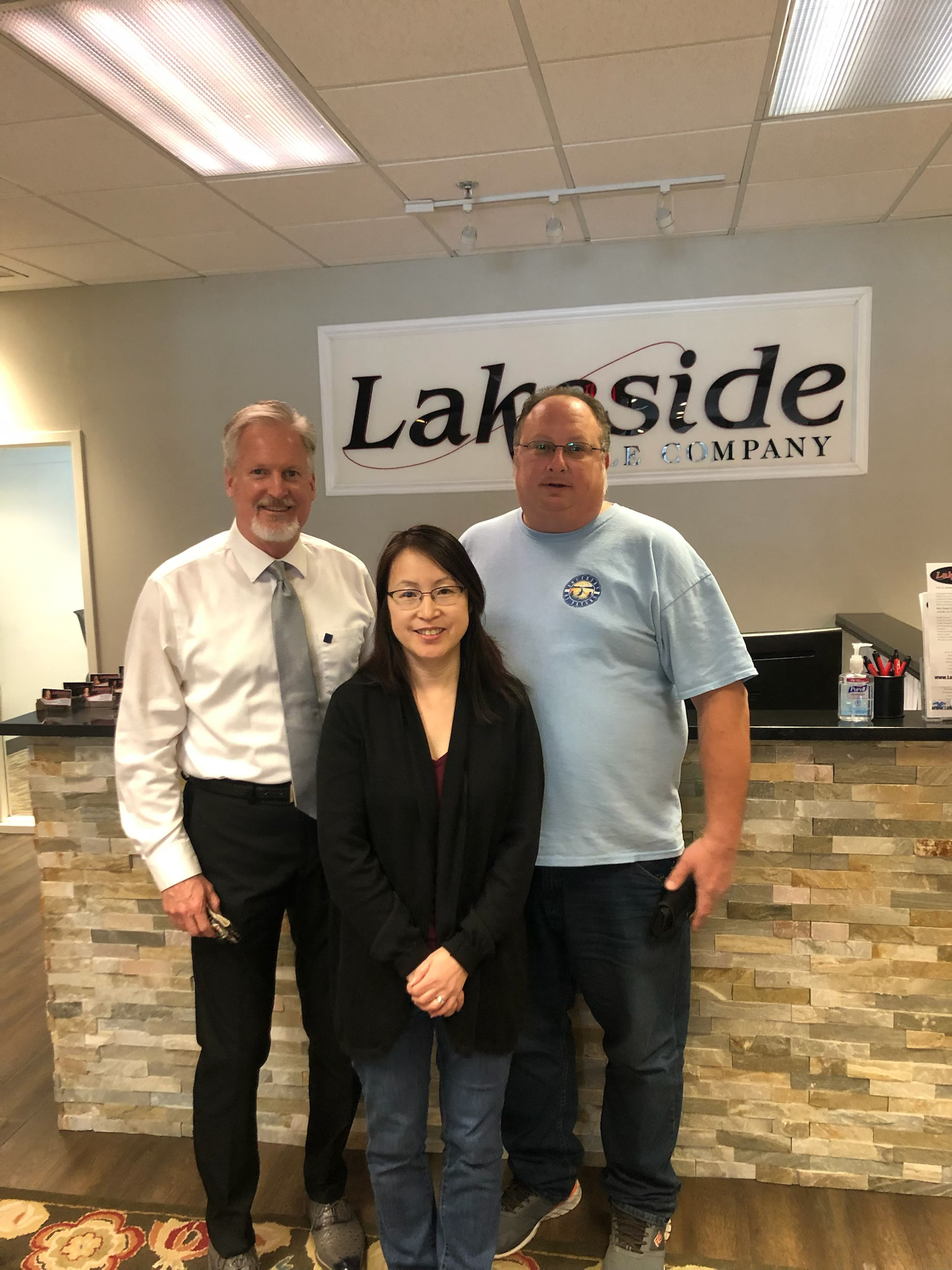 Happy clients at Lakeside Title Company after closing